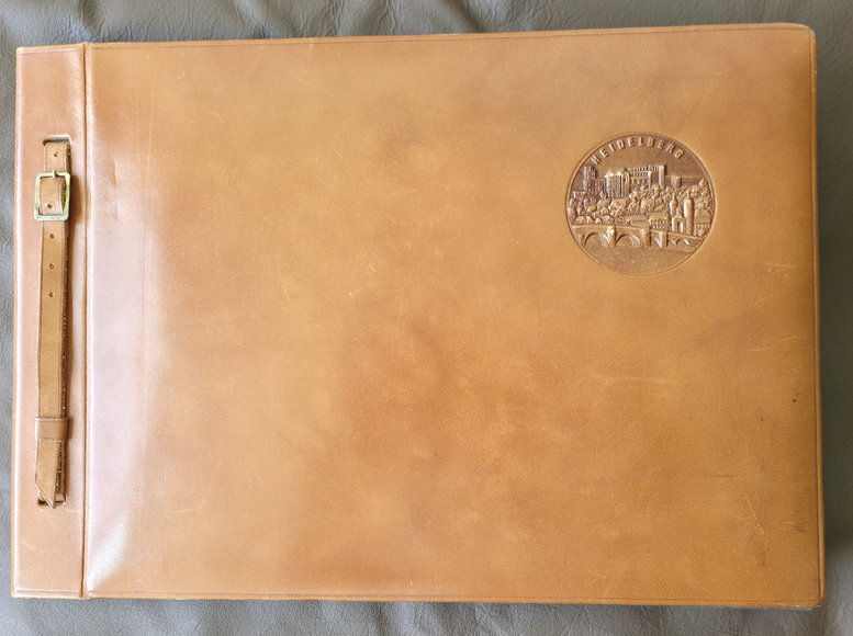 The album's leather cover, with its stamped emblem
